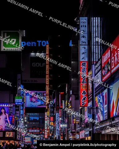 Tokyo, Japan - June 2025: Colorful neon signs and storefronts light up a narrow Kabukicho street in Shinjuku after dark.
