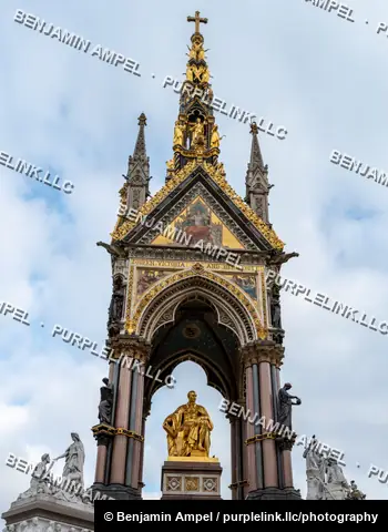 London, England - October 2025: The ornate Gothic Revival spire of the Albert Memorial rises with gilded statues and mosaics above Kensington Gardens.