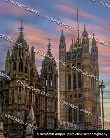 The pinnacled towers of the Palace of Westminster rise against a pink and blue dusk sky in London.