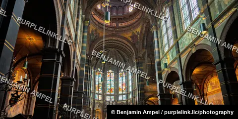 Amsterdam, Netherlands - June 2026: Ornate frescoes and stained glass windows fill the apse of the Basilica of Saint Nicholas.