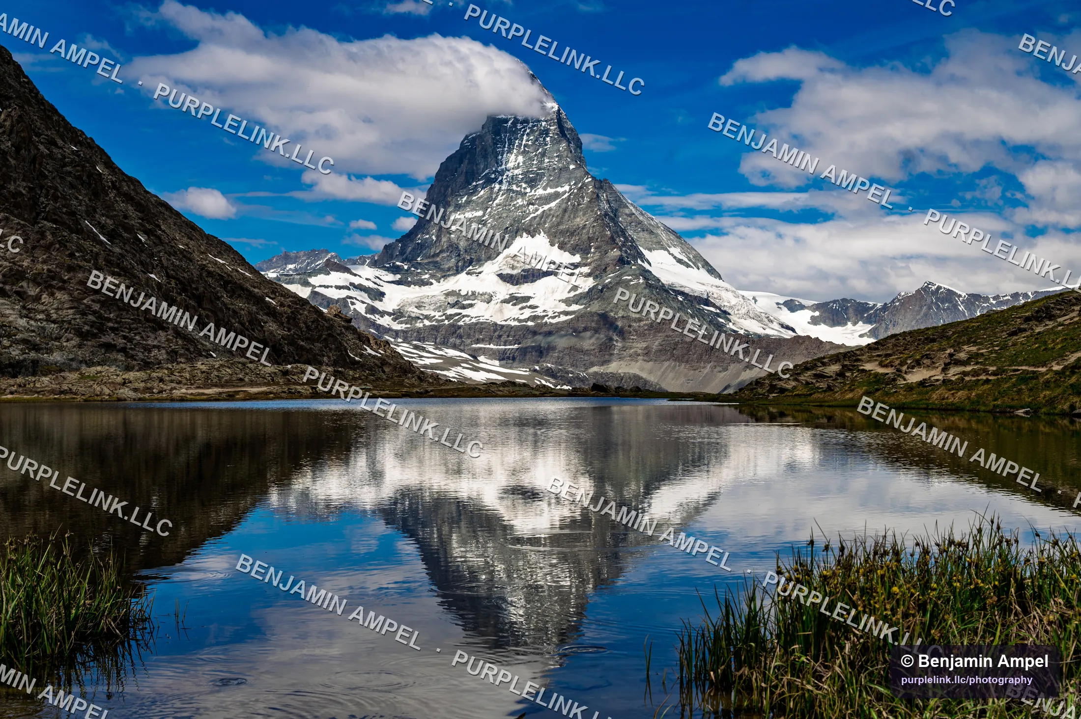 The Matterhorn reflected in the still water of Riffelsee under a deep blue sky