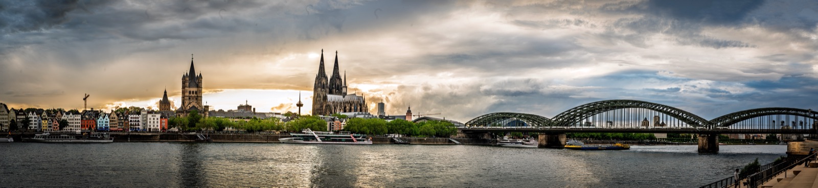 Cologne skyline with the cathedral and the Hohenzollern Bridge over the Rhine at sunset